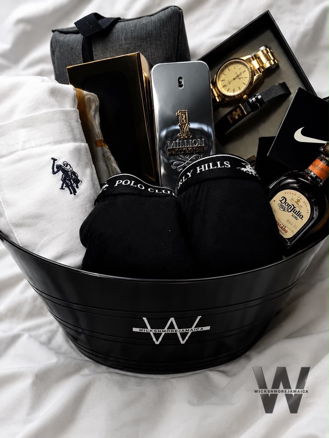 A sleek black luxury gift set with designer fragrance and accessories